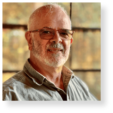 Experienced man with glasses, smiling outdoors, showcasing confidence and professionalism for Richard Comparey expert profile.